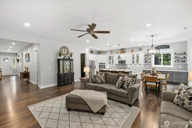 Massive great room features gourmet kitchen, LVP flooring, coffee bar area.  All open to extra wide slider door to the back and wide hallway to front.