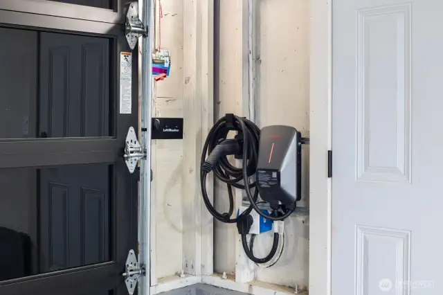 EV charger in garage and door to RV parking space.