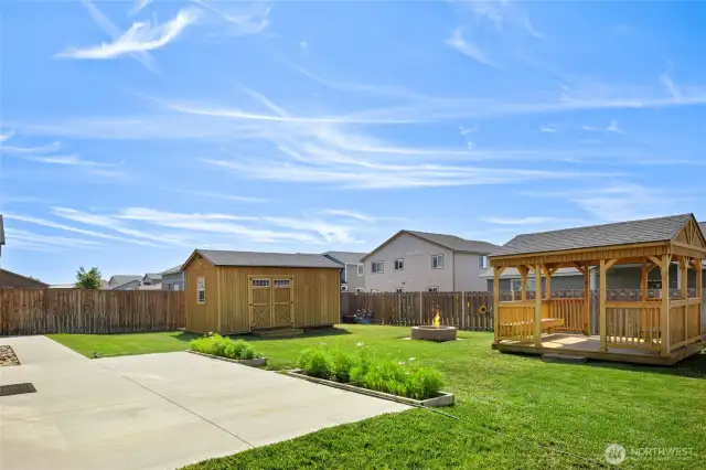 A quick look at the back yard with the oversized patio (with a retractable awning!) and the gazebo, firepit and storage/workshop building!