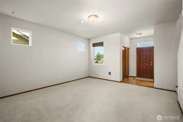 Main floor living area looking towards front door and powder room