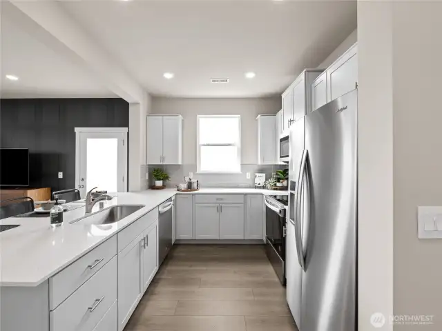 Long prep counter with undermount sink keeps the chef connected to guests across the open concept layout. Pictures are for representational purposes only, colors and features may vary.
