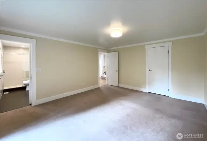 The primary bedroom has a magnificent tiled bathroom with double sinks and a view as well as a walk in with custom closet organizer.