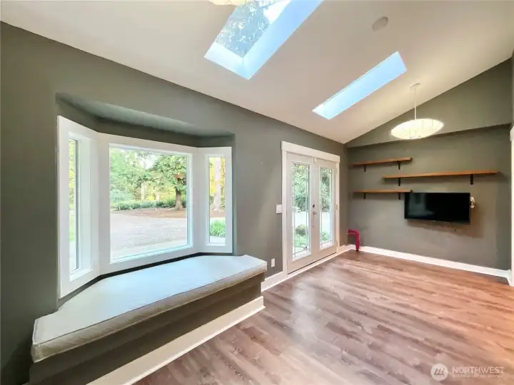 French doors, skylights and a bay window letting the light cascade into this great space... This was used as an office and with a double outside entry door it is very versatile.