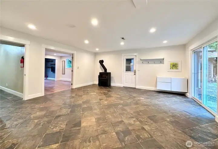 Lower level is a large space and is extremely versatile. Door to the back yard and garage.