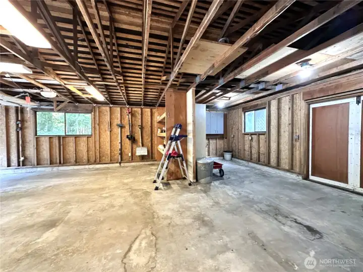 Oversized two car garage with shop or storage space and a double door to the back yard for easy access.