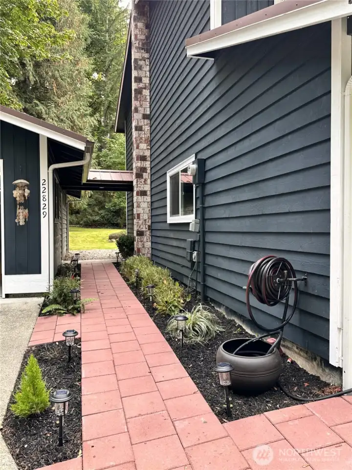 Great flow inside and out... The covered walkway from the garage to the home is one of many thoughtful design features in this home.