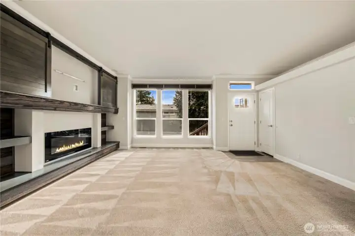 The same view of the living area (unstaged) highlights the room’s flexibility and seamless flow for everyday living.