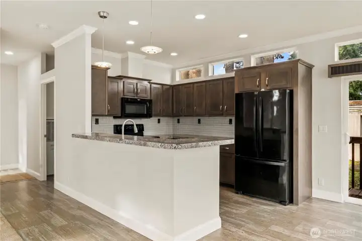 Kitchen features a spacious peninsula, ample cabinetry, and a layout designed for both function and flow.