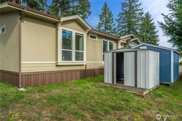 Two detached storage sheds provide convenient space for tools, seasonal items, or outdoor equipment.