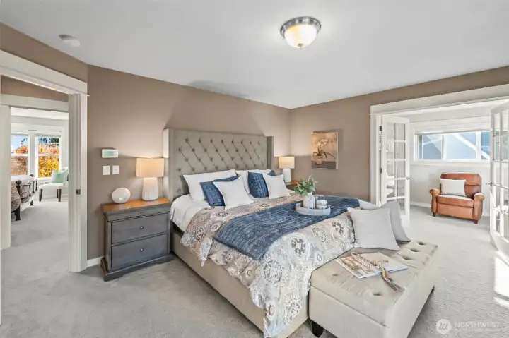 Upstairs primary bedroom in Horizon West home for sale in North Gig Harbor featuring a spacious layout with cozy sitting area, plush carpeting, and natural light—creating a relaxing retreat in this gated community near Downtown Gig Harbor.