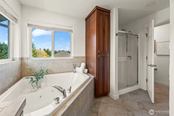 Primary ensuite bathroom in Horizon West home for sale in North Gig Harbor showcasing a walk-in shower, rich cherry cabinetry, and a private water closet—designed for both style and functionality in this luxurious upstairs retreat.