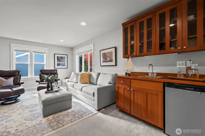 Bonus media room above the garage in Horizon West home for sale in North Gig Harbor featuring a wet bar, ample space for entertaining, and flexible use as a home theater, game room, or fitness area.