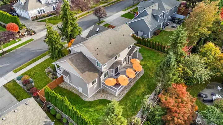 Aerial view of Horizon West home for sale in North Gig Harbor showcasing the fenced backyard, expansive Trex deck, and covered patio—ideal for outdoor entertaining and enjoying the Pacific Northwest lifestyle.