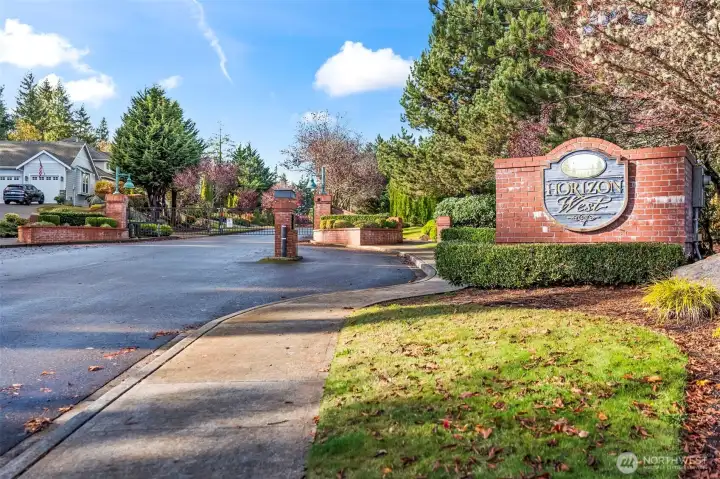 Front gate entrance of Horizon West community in North Gig Harbor featuring secure access, sidewalks, parks, and playgrounds—offering a walkable, friendly neighborhood close to shopping, golf, and Hwy 16.