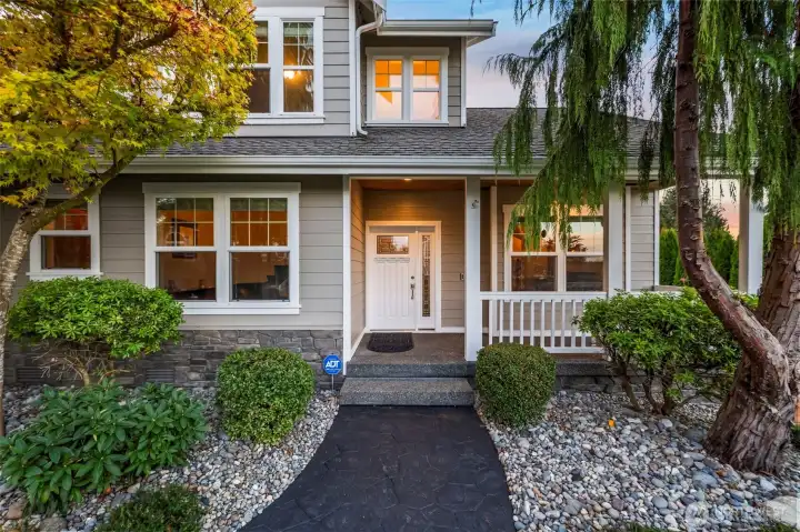 Front entrance of Horizon West home for sale in North Gig Harbor featuring a charming covered porch and inviting entry—creating a warm “Welcome Home” finish to this beautifully maintained property in a gated community.