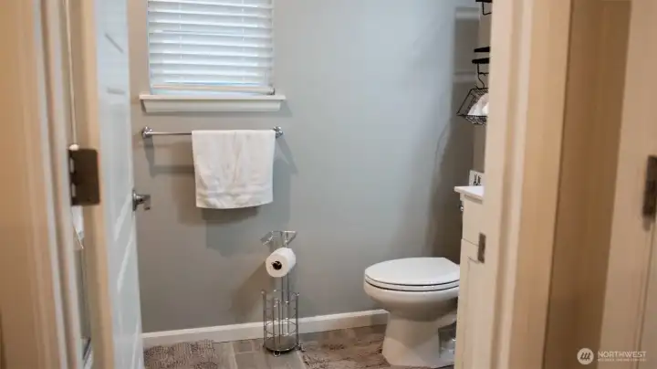 Main floor full bath provides easy access for guests and everyday living, complete with a convenient shower