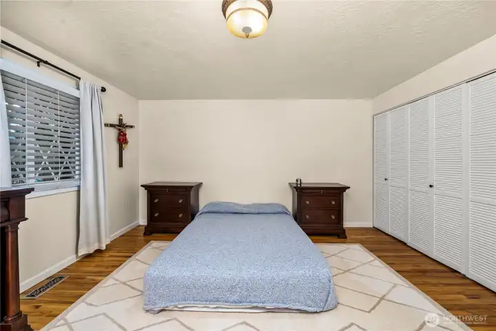 Primary bedroom with hardwood floors.