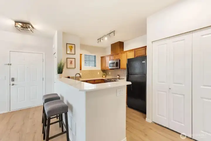 New kitchen with bar-top for eating & entertaining.  Updated lighting.