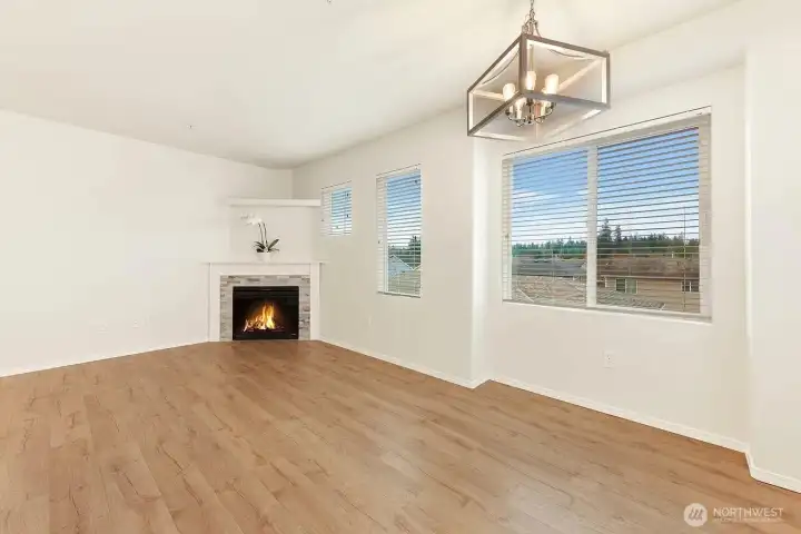 Large family room with big bright windows and new engineered hardwood flooring.