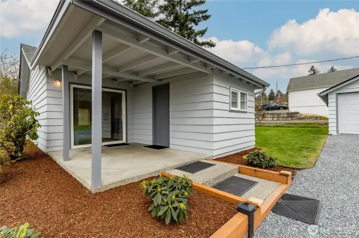 Covered back patio and newly refreshed landscaping