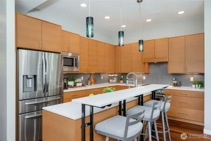 The kitchen features quartz countertops, stainless steel appliances, and gas cooking The kitchen features quartz countertops, stainless steel appliances, and gas cooking