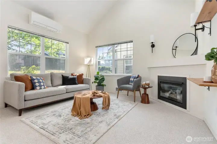 Soaring vaulted ceilings and a sun-filled skylight bathe the open-concept living space in natural light. Soaring vaulted ceilings and a sun-filled skylight bathe the open-concept living space in natural light.
