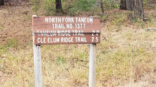 This sign and trail are a few hundred feed West of the location to walk up the hill to the land. This trail may get you there also.