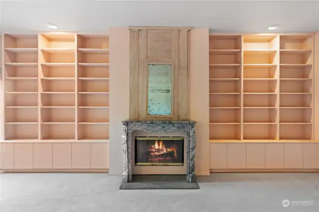 Built ins flank the fireplace to showcase your library or private collection