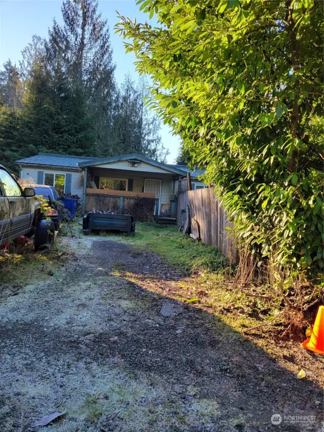 View of the home from the street. Mostly fenced yard.