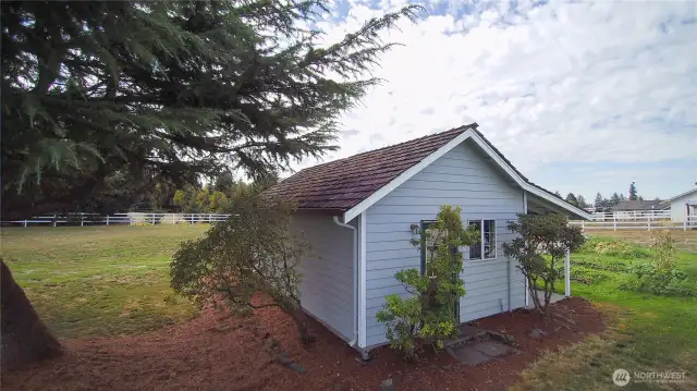 Charming detached shed versatile space for a garden shed, workshop, or extra storage area.