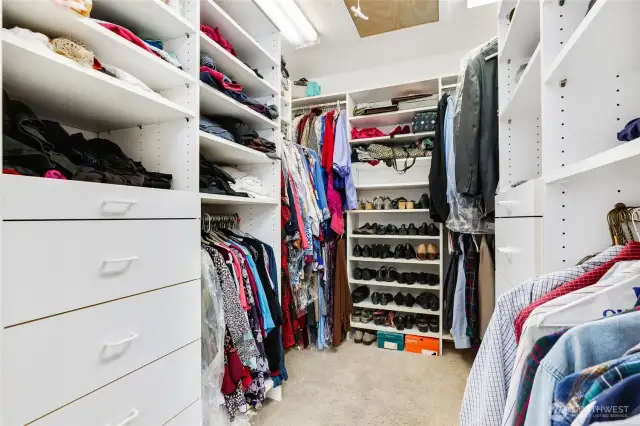 Walk-in closet with built-ins and attic access.