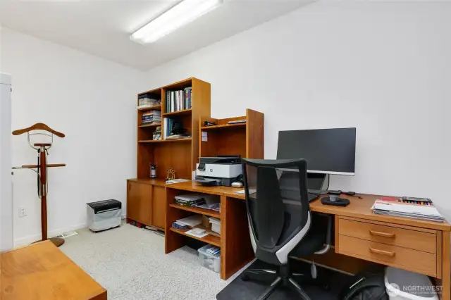 Versatile room off the primary ensuite, perfect for an office or exercise space, featuring an electric skylight that fills the room with natural light.