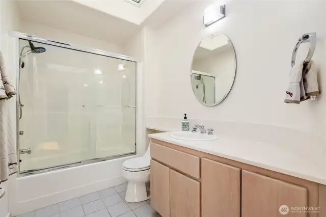 Full bath conveniently located off the entry, serving the secondary bedrooms, with ample space and a functional layout.