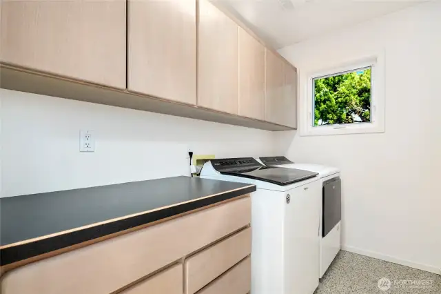 Convenient laundry room featuring ample storage space, making organization and chores a breeze.