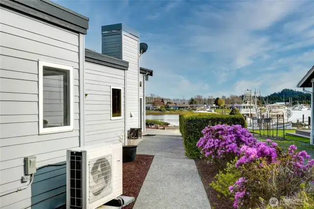 Sidewalk extends from driveway to dock, offering a scenic path to the water's edge.