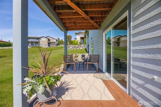 Deck & paved courtyard off lower level bedroom 3 lead to expansive open space yard