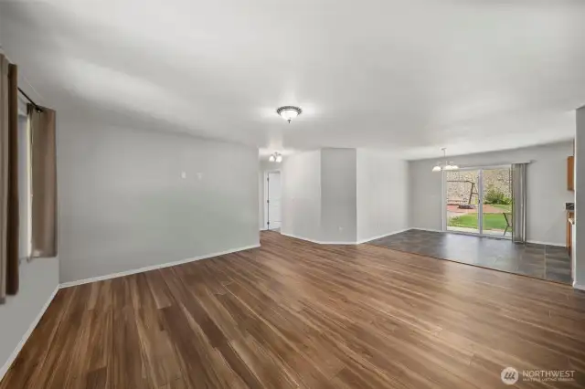 Brand new LVP floors in living room. Living room looking into dining room.