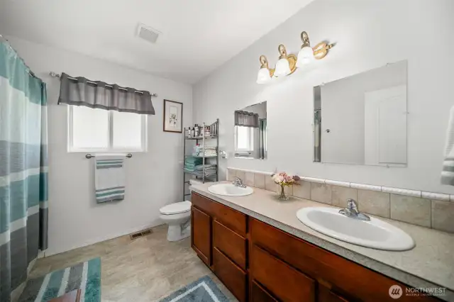 Full Primary Bathroom with dual vanities and dual sinks.