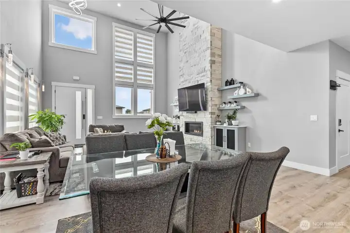 Living room with stacked stone fireplace from floor to ceiling, custom lighting fixtures.