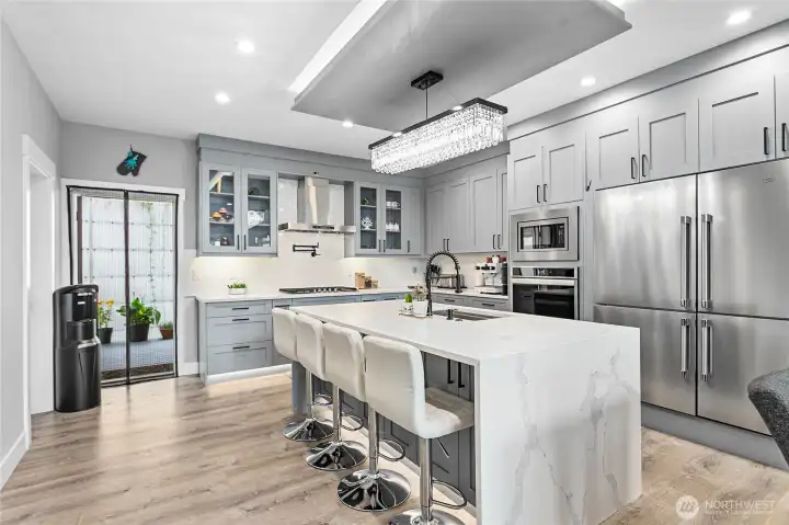 Kitchen with side by side fridge/freezer, built in wall oven.