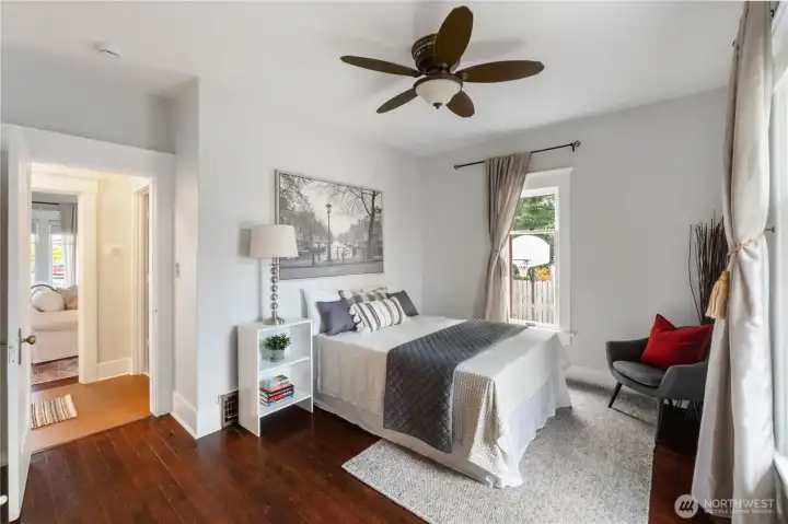 Main floor bedroom with walk in closet and original wood floors