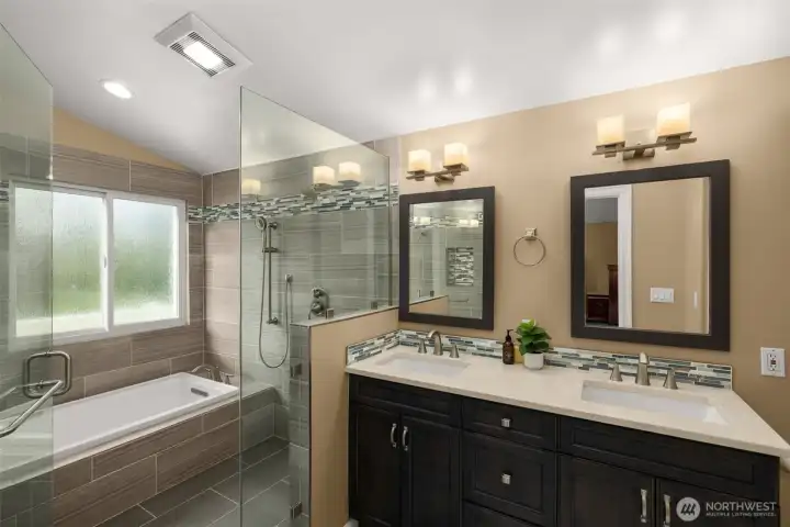Primary ensuite, walk-in shower with soaking tub and a double sink quartz vanity.