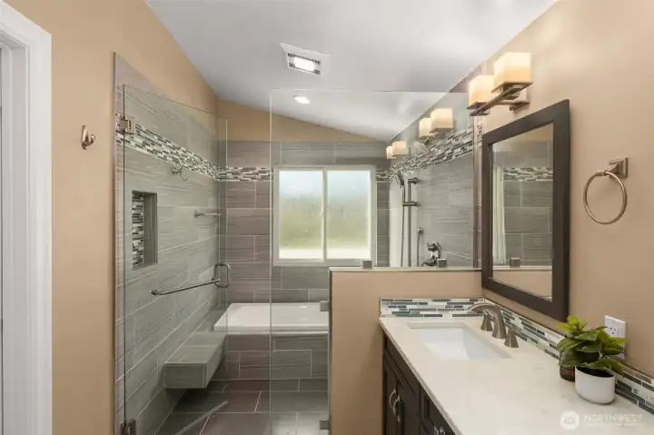 Primary ensuite, walk-in shower with soaking tub and a double sink quartz vanity.