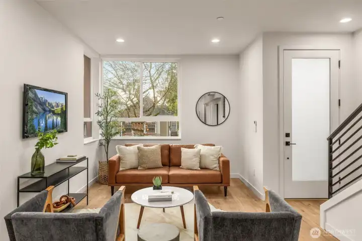 Cozy entry way living area, has tv hookup. Creates a natural gathering place for all residents & makes a great spot for entertaining