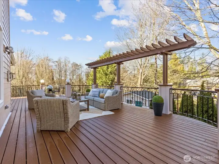 Huge deck for entertaining adjacent to the kitchen. There are stairs down to the lower level.