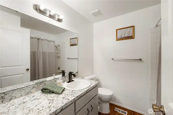 Large bath down the hall. Tub and shower with tile surround.