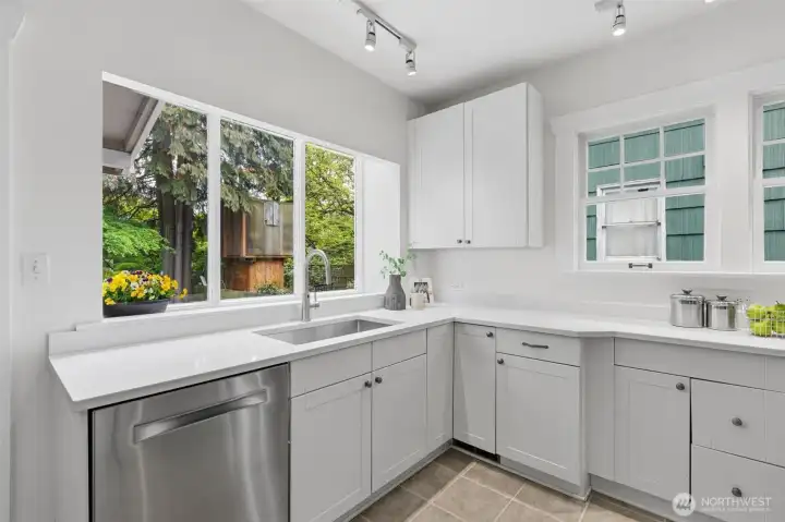 Newly installed quartz countertops, backsplash and stainless steel sink and faucet