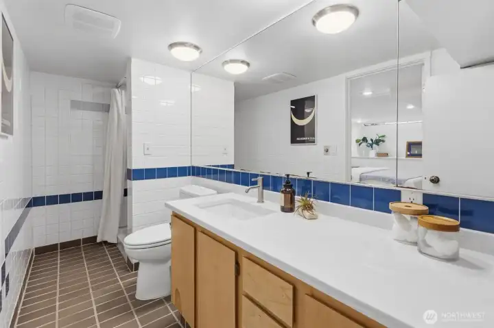 3/4 bathroom with fresh quartz countertops, sink and faucet