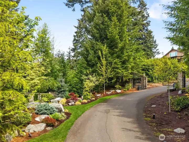 Looking back at the entry. Road is lined with lights. Landscaping all served by sprinkler system.
