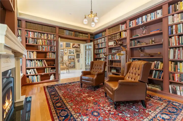 Library with fireplace is a good place to cozy up to a good book....or turn on the TV.